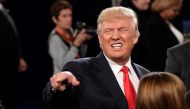 Republican nominee Donald Trump poses with members of the audience after the second presidential debate at Washington University in St. Louis, Missouri on October 9, 2016. AFP / POOL / SAUL LOEB
