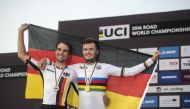 Germany's silver medallist Maximilian Schachmann (L) and gold medallist Marco Mathis celebrate on the podium at the end of the men's under 23 individual time trial event as part of the 2016 UCI Road World Championships on October 10, 2016, in the Qatari c