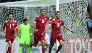 Qatar’s Hassan Al Haydos (right) celebrates after scoring a penalty during their 2018 World Cup qualifying football match against Syria at the Jassim Bin Hamad Stadium in Doha yesterday.