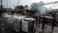 A truck was turned over after an explosion during a fire at fireworks shop in Bocaue, Bulacan, north of Manila on October 12, 2016. A fire that ripped through a group of fireworks shops in the Philippines has killed one person with another missing and six