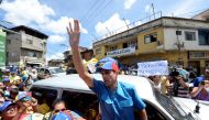 Venezuelan opposition leader Henrique Capriles waves at supporters in Redoma de las Minas de Baruta, in Caracas, on October 12, 2016 to press for a recall referendum against President Nicolas Maduro. Venezuela's opposition called protest against Maduro in