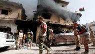 Smoke rises from a ruined house after it was hit by an air strike as fighters from Libyan forces allied with the U.N.-backed government advance into the last area controlled by Islamic State, in Sirte, Libya, October 14, 2016. Reuters/Ismail Zitouny