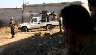 Fighters from the Free Syrian Army fire a machine gun mounted on a vehicle deploy during fighting against the Islamic State (IS) group jihadists on the outskirts of the northern Syrian town of Dabiq, on October 15, 2016.  AFP / Nazeer al-Khatib