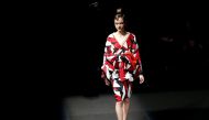 A model presents a creation by designer Yoshiki, leader of Japan's band 