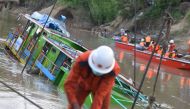 Rescue personnel from the Myanmar Fire Services Department refloat a ferry which sank in the Chindwin River in the Sagaing region on October 19, 2016.  AFP / STR