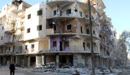 A man walks past damaged buildings in the rebel held besieged al-Sukkari neighbourhood of Aleppo, Syria October 19, 2016. REUTERS/Abdalrhman Ismail