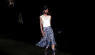 Japanese model Rina Fukushi presents a creation by Japanese designer Tae Ashida during the Tae Ashida 2017 Spring/Summer collection show in Tokyo. AFP / BEHROUZ MEHRI 
