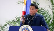 Philippine President Rodrigo Duterte gestures as he speaks at the Davao International Airport after arriving back from a state visit to Brunei and China on October 22, 2016. AFP / Manman Dejeto 