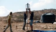 Israeli settlers start to build a new illegal outpost north of the West Bank Palestinian village of Ain al-Baida on October 25, 2016. More than 400,000 Israelis live in settlements in the occupied West Bank, considered by the international community one o