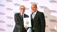 Sulaiman Yousif Al Salhi (right) breceiving the award on behalf of QFB. 