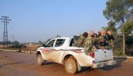 Rebel fighters from the Jaish al-Fatah (or Army of Conquest) brigades drive a pick-up on October 29, 2016 in the neighbourhood of Dahiyet al-Assad, southwest of Aleppo, after they retook control of the area.  AFP / Omar haj kadour