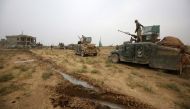 OPERATION. Iraqi forces wait on their vehicles in the village of Umm Mahahir, south of Mosul, on October 28, 2016 after they recaptured it from the Islamic State (IS) group jihadists as part of their operation to retake the main hub city of Mosul. Ahmad A
