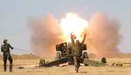 Popular Mobilization Forces (PMF) personnel fire artillery during clashes with Islamic State militants south of Mosul October 29, 2016. REUTERS/Stringer