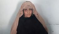 In this handout photograph released by Pakistan's Federal Investigation Agency (FIA) on October 26, 2016, Afghan Sharbat Gula, the 'Afghan Girl' who appeared on the cover of a 1985 edition of National Geographic magazine, waits ahead of a court hearing in