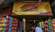 A man lights a cigarette in front of a kiosk in Kolkata, India, April 7, 2016. (REUTERS / Rupak De Chowdhuri) 