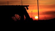 A sunset is pictured near a destroyed building in Bartella, east of Mosul, Iraq November 3, 2016. Picture taken November 3, 2016. REUTERS/Zohra Bensemra
