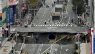 A huge sinkhole is seen at an intersection near Hakata station in Fukuoka, Japan, November 8, 2016 in this photo taken by Kyodo. credit Kyodo/via REUTERS 