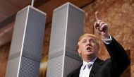 (FILES) This file photo taken on May 18, 2005 shows Real estate developer Donald Trump holding a news conference at Trump Tower, standing next to a nine-foot model of his proposed Twin Towers II, an alternative to the Freedom Tower design that was approve