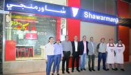Camille E Aoun (centre), CEO of Shawarmanji, Georges Chamassian, General Manager of Al Mazak and the staff, in front of the outlet.