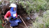Aleida Toro works with her mine detector in a zone where landmines were planted by rebel groups near Sonson in Antioquia province, November 19, 2015. Women's work takes on a nontraditional meaning for fifteen Colombian women who work to rid the Antioquia 