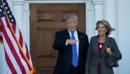 (FILES) This file photo taken on November 18, 2016 shows president-elect Donald Trump and Betsy DeVos after their meeting at Trump International Golf Club, in Bedminster Township, New Jersey. AFP / GETTY IMAGES NORTH AMERICA / Drew Angerera