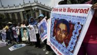 Relatives hold pictures of some of the 43 missing students of Ayotzinapa College Raul Isidro Burgos, as they take part in a protest to demand justice for the missing students, near the Interior Ministry in Mexico City, Mexico April 15, 2016. Reuters / Hen