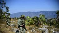 Mexican soldiers search for corpses in the surroundings of a mass grave, in the Zitlala municipality, Guerrero State, Mexico on November 25, 2016. AFP / RONALDO SCHEMIDT