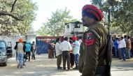 An Indian police personnel and onlookers stand near the gate of the Nabha maximum-security jail in Nabha in the state of Punjab on November 27, 2016. AFP / STR