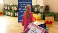  Syrian refugees in Jordon receiving winter assistance at a distribution centre set by RAF.
