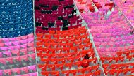 A worker hangs clothes to dry on the roof of a garment factory in Dhaka in this June 15, 2005 file photo. REUTERS/Rafiqur Rahman/Files
