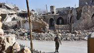 A member of the Syrian pro-government forces patrols Aleppo's Bab al-Nairab neighbourhood on December 10, 2016. Syria's government has retaken at least 85 percent of east Aleppo, which fell to rebels in 2012, since beginning its operation on November 15. 