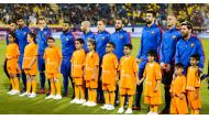 Barcelona team pose for a photograph with six-year-old Afghan boy Murtaza Ahmadi and other kids before their match against Al Ahli in Doha.
