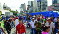 People queue outside Venezuela's Central Bank in Caracas to change 100 bolivar notes, yesterday.