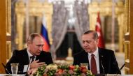 This file photo taken on October 10, 2016 shows Russian President Vladimir Putin (L) speaking to Turkish President Recep Tayyip Erdogan (R) as they attend a press conference in Istanbul. Veteran diplomat Andrei Karlov was shot nine times in the back by an