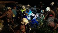 This handout from Malaysia Fire and Rescue Department taken on December 24, 2016 shows rescuers helping a bus crash survivor in Muar, outside Kuala Lumpur. AFP PHOTO / MALAYSIA FIRE AND RESCUE DEPARTMENT