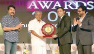 Joyalukkas Group Executive Director John Paul Alukkas (second right) receiving the Young NRI Entrepreneur of the Year Award for 2016 from Chief Minister of Kerala, Prinarayi Vijayan, as Malayalam Communications Ltd Chairman, and cinema superstar Mamooty (