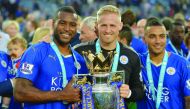 Leicester City’s goalkeeper Kasper Schmeichel (centre) with Wes Morgan (left) and Danny Simpson lift the Premier League trophy at the King Power Stadium in Leicester, Britain, in this May 2016 file photo.