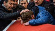 Relatives of Ayhan Arik, one of the victims of the Reina nightclub attack, mourn during his funeral. Photograph: Ozan Kose/AFP.