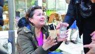 A woman reacts as she is given a glass of water near the scene of a car bomb outside the courthouse in Izmir, yesterday.