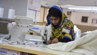 In this photograph taken on November 16, 2016, a Pakistani machinist works at a textile factory in Faisalabad. As Pakistan slowly emerges from a long-term power crisis, its once booming textile sector is scrambling to find its feet -- but high energy cost