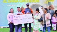 Dr R Seetharaman, CEO of Doha Bank, giving away the prize to an Al Dana millionaire.