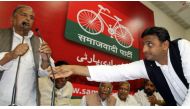 Akhilesh Yadav of Uttar Pradesh adjusts microphone for his father Mulayam Singh Yadav during a Samajwadi Party meeting in Lucknow, March 10, 2012 (Reuters file) 