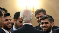 Chief opposition negotiator Mohammad Alloush (R) of the Jaish al-Islam (Army of Islam) rebel group listens to UN envoy for Syria Staffan de Mistura prior to the first session of Syria peace talks at Astana's Rixos President Hotel on January 23, 2017. / AF