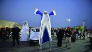 A stilt walker entertains the crowd on the last day of Winter Festival at Katara yesterday. Pic Baher Amin / The Peninsula