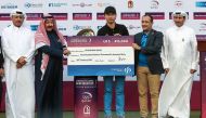 South Korea's Wang Jeungh poses with a cheque bearing his prize after winning the Qatar Masters golf tournament at the Doha Golf Club in Doha on January 29, 2017. (AFP / KARIM JAAFAR)