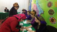 A woman signs to collect her ballot during a presidential election at a polling station in Ashgabat, Turkmenistan, February 12, 2017. REUTERS/Marat Gurt