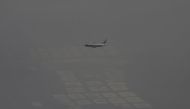 FILE PHOTO: An Air China passenger aircraft flies amid heavy smog over the suburb of Beijing, China, January 2, 2017. REUTERS/Jason Lee/File Photo

