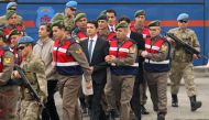 Turkish soldiers accused of attempting to assassinate President Tayyip Erdogan on the night of the failed last year's July 15 coup, are escorted by gendarmes as they arrive for the first hearing of the trial in Mugla, Turkey, February 20, 2017. REUTERS/Ke