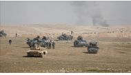 Iraqi security forces are seen on military vehicles as they advance towards Mosul International Airport Soldiers during an operation carried out to retake western part of Mosul from Daesh in Mosul, Iraq on February 20, 2017. ( Yunus Kele? - Anadolu Agency