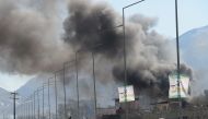 Smoke rises from an Afghan police district headquarters building after a suicide car bombing in Kabul on March 1, 2017.  AFP / SHAH MARAI
